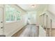 Sun-drenched sunroom featuring vinyl flooring, large windows offering serene outdoor views, and crisp white trim at 1350 Lori Ct, Conley, GA 30288
