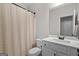Clean bathroom with white marble vanity and shower featuring light-colored curtain for added privacy at 9178 Lakeview Pkwy, Villa Rica, GA 30180