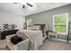 Comfortable bedroom with a tray ceiling, stylish decor, and plenty of natural light at 9178 Lakeview Pkwy, Villa Rica, GA 30180