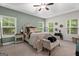 Serene bedroom with a tray ceiling, large windows, and a cozy seating area at 9178 Lakeview Pkwy, Villa Rica, GA 30180
