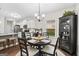 Charming dining area featuring a round table, elegant lighting, and an open view to the kitchen at 9178 Lakeview Pkwy, Villa Rica, GA 30180