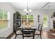 Bright dining room with a large window and an elegant round table set for a meal at 9178 Lakeview Pkwy, Villa Rica, GA 30180