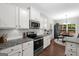Well-appointed kitchen with granite countertops, stainless steel appliances, and an adjacent dining area at 9178 Lakeview Pkwy, Villa Rica, GA 30180