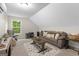 Cozy living room area with plush seating, a stylish rug, and natural light from a window at 9178 Lakeview Pkwy, Villa Rica, GA 30180