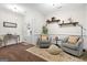 A sitting room with hardwood floors, neutral walls, trim, and comfortable seating provides a cozy retreat at 9178 Lakeview Pkwy, Villa Rica, GA 30180