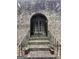 Arched front entrance and decorative iron gate of a charming brick house at 2219 Riverbrook Rd, Decatur, GA 30035