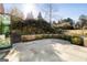 Stone patio with privacy landscaping and a black BBQ grill at 818 Springdale Ne Rd, Atlanta, GA 30306