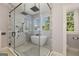 Luxurious bathroom featuring a glass-enclosed shower, standalone tub, and elegant tile work at 818 Springdale Ne Rd, Atlanta, GA 30306