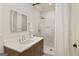 Modern bathroom featuring a sleek vanity, stylish mirror, and a walk-in shower with elegant tile work at 818 Springdale Ne Rd, Atlanta, GA 30306