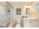 Bright bathroom features a shower and tub combination with white tile surround and modern vanity at 818 Springdale Ne Rd, Atlanta, GA 30306