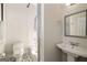 Cozy bathroom with pedestal sink, tiled shower/tub, and black and white tiled floors at 818 Springdale Ne Rd, Atlanta, GA 30306