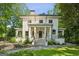 Charming two-story home features classic white columns and manicured landscaping enhancing its curb appeal at 818 Springdale Ne Rd, Atlanta, GA 30306