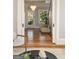 Stylish interior view through an arched doorway showing herringbone floors and a staircase with light-filled windows at 818 Springdale Ne Rd, Atlanta, GA 30306