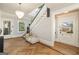 Elegant foyer features herringbone wood floors, staircase, and a stylish chaise lounge at 818 Springdale Ne Rd, Atlanta, GA 30306
