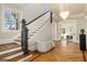 Elegant foyer featuring a stunning staircase, hardwood floors, and a statement chandelier at 818 Springdale Ne Rd, Atlanta, GA 30306