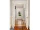 Elegant hallway with French doors, paneled walls, and a glimpse of herringbone floors leading to the front door at 818 Springdale Ne Rd, Atlanta, GA 30306