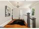 Upstairs hallway with hardwood floors, decorative rug, and stairway railing at 818 Springdale Ne Rd, Atlanta, GA 30306