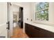 Hallway with storage and natural light, showcasing the hardwood flooring at 818 Springdale Ne Rd, Atlanta, GA 30306