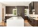 Modern kitchen boasts a large island, sleek cabinets, stainless steel appliances, and hardwood floors at 818 Springdale Ne Rd, Atlanta, GA 30306