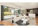 Open living room with modern sofa and floor-to-ceiling folding glass doors at 818 Springdale Ne Rd, Atlanta, GA 30306