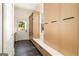 Bright mudroom with custom built-in cabinets, bench seating, and slate tile floor at 818 Springdale Ne Rd, Atlanta, GA 30306
