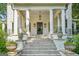 Inviting front porch with grand columns and decorative planters leading to the home's entrance at 818 Springdale Ne Rd, Atlanta, GA 30306