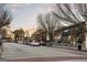 Street view showcasing a lively street with retail storefronts and diverse architectural styles under a colorful sky at 818 Springdale Ne Rd, Atlanta, GA 30306