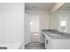 Clean bathroom features a granite countertop, bathtub, white cabinets, and modern fixtures at 455 Prescott Way, Villa Rica, GA 30180