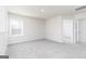 Spacious bedroom with neutral carpet, a window, and a doorway leading to another room at 455 Prescott Way, Villa Rica, GA 30180