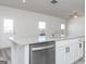 Close-up of sink on the kitchen island with stylish countertops and stainless steel dishwasher at 455 Prescott Way, Villa Rica, GA 30180