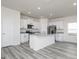 Bright kitchen boasts white cabinets, stainless steel appliances, and granite countertops at 455 Prescott Way, Villa Rica, GA 30180