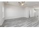Spacious living room with stylish gray flooring, natural light, and a ceiling fan at 455 Prescott Way, Villa Rica, GA 30180
