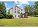 View of back exterior featuring a spacious yard, and a beautiful two-story wooden deck, perfect for entertaining at 44 Willow Leaf Way, Sharpsburg, GA 30277
