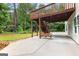 Backyard patio underneath a wooden deck, featuring a cozy swing and ample space at 44 Willow Leaf Way, Sharpsburg, GA 30277