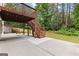 Outdoor patio beneath a wooden deck structure, complete with staircase and swing at 44 Willow Leaf Way, Sharpsburg, GA 30277