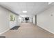 Expansive finished basement with double doors, carpet flooring, and a tv on the wall at 44 Willow Leaf Way, Sharpsburg, GA 30277