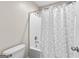 Modern bathroom featuring a toilet and shower/tub with a patterned curtain at 44 Willow Leaf Way, Sharpsburg, GA 30277