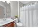 Bathroom vanity with sink, toilet, and shower with decorative curtain at 44 Willow Leaf Way, Sharpsburg, GA 30277