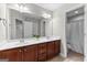 Bathroom vanity with double sinks and a large mirror with view into the toilet/shower area at 44 Willow Leaf Way, Sharpsburg, GA 30277