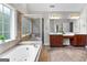 Bathroom featuring large soaking tub, tiled walk-in shower, and double vanity sinks at 44 Willow Leaf Way, Sharpsburg, GA 30277