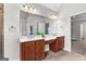 Bathroom featuring double vanity sinks, large mirror, and view of the water closet at 44 Willow Leaf Way, Sharpsburg, GA 30277