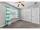 Bedroom featuring ceiling fan, large window, and closet for ample storage at 44 Willow Leaf Way, Sharpsburg, GA 30277