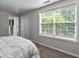 Bright bedroom with a large window and neutral decor, creating a serene and inviting space at 44 Willow Leaf Way, Sharpsburg, GA 30277