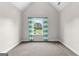 Bright bedroom featuring a large window with stripped curtains and neutral carpet at 44 Willow Leaf Way, Sharpsburg, GA 30277