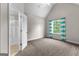Bedroom with neutral carpet and view into the open bathroom doorway at 44 Willow Leaf Way, Sharpsburg, GA 30277