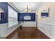 Elegant dining room showcasing dark blue walls, hardwood floors, and a decorative chandelier at 44 Willow Leaf Way, Sharpsburg, GA 30277