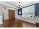 Elegant dining room featuring a sliding door, hardwood floors, and a decorative chandelier at 44 Willow Leaf Way, Sharpsburg, GA 30277