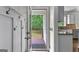 Welcoming entryway with coat hooks leads to an outdoor porch and open kitchen area at 44 Willow Leaf Way, Sharpsburg, GA 30277