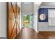 Bright foyer with an open door and views to the outdoors, dark hardwood floors, and statement sliding doors at 44 Willow Leaf Way, Sharpsburg, GA 30277