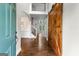Inviting foyer with dark hardwood floors, statement sliding doors, and a view into the living area at 44 Willow Leaf Way, Sharpsburg, GA 30277